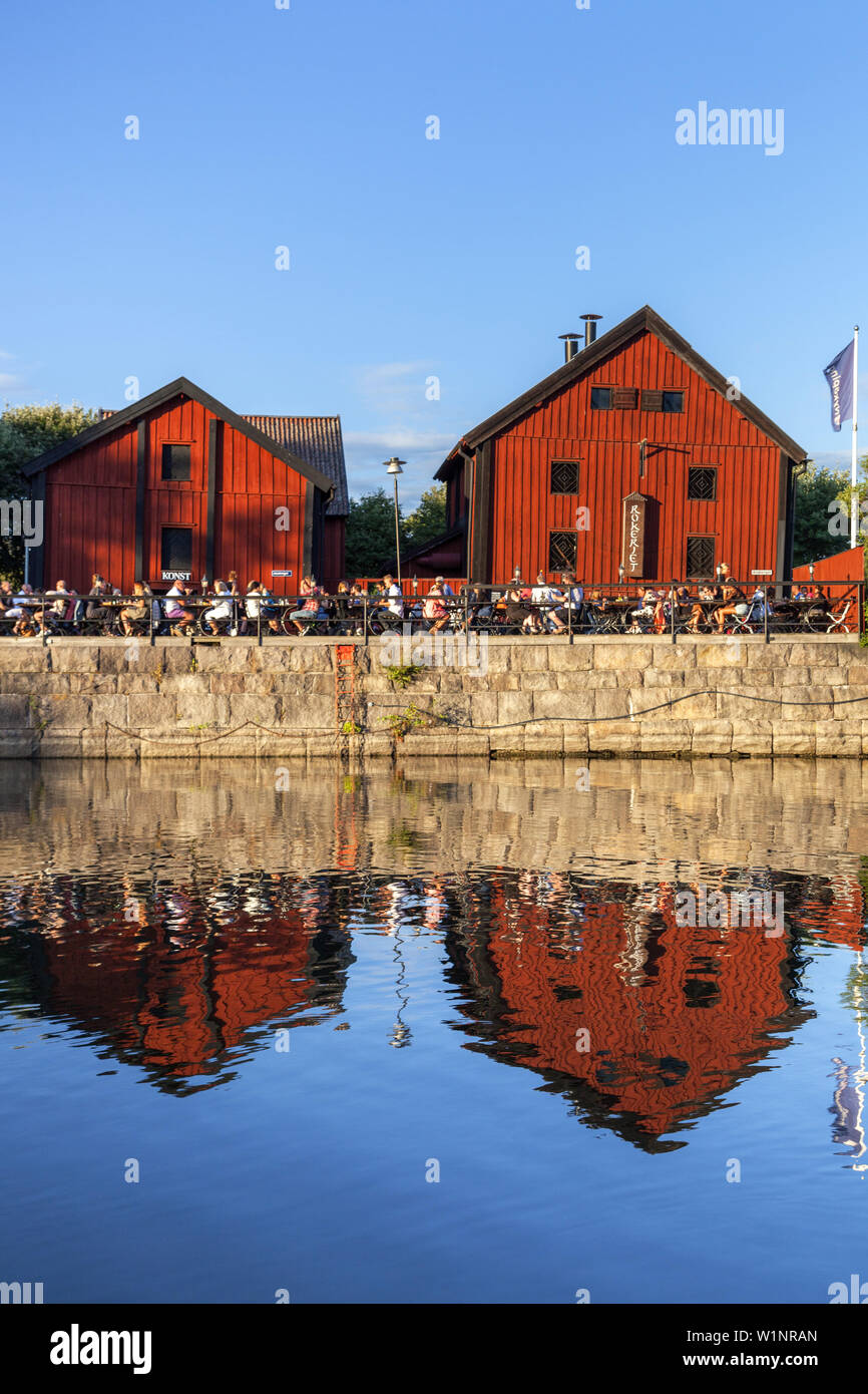 People sitting outside in the restaurant Rökeriet in the harbour of Nyköping, Södermanland, South Sweden, Sweden, Scandinavia, Northern Europe, Europe Stock Photo