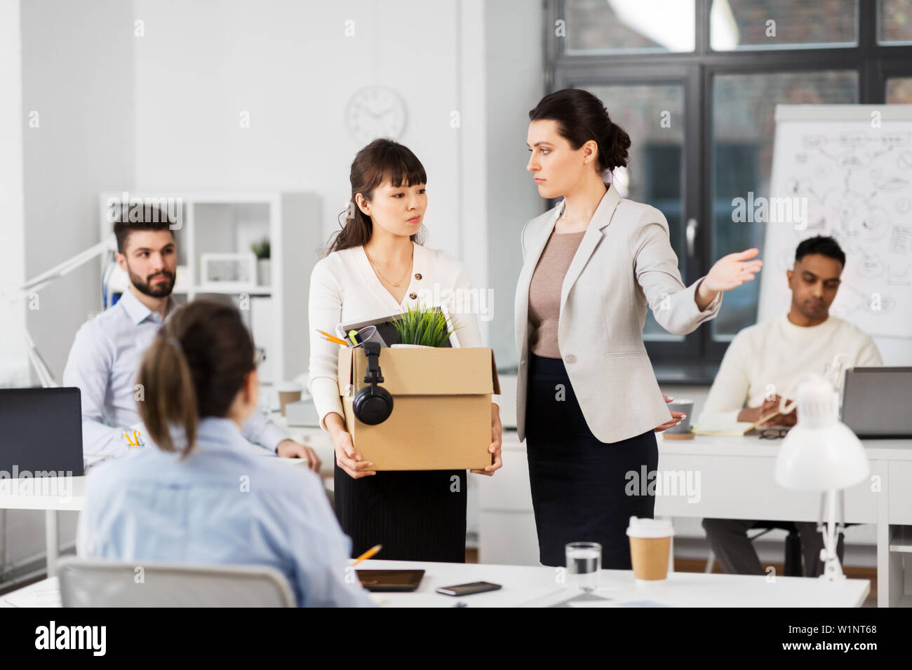 fired sad female office worker leaving Stock Photo