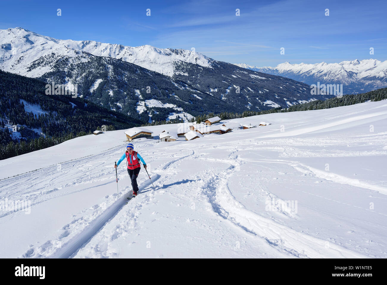 Woman back-country skiing ascending towards Gilfert, view to Nonsalm, valley of Inn and Karwendel range, Gilfert, Tux Alps, Tyrol, Austria Stock Photo