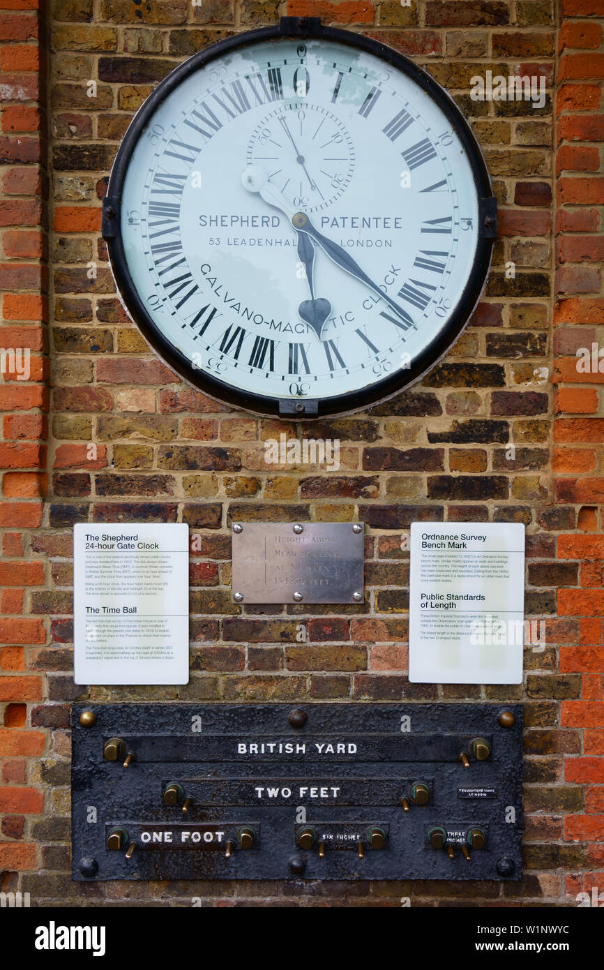 Shepherd 24-hour Gate Clock displaying Greenwich Mean Time GMT and Public Standards of Length at the Royal Observatory Greenwich, London, UK. Stock Photo