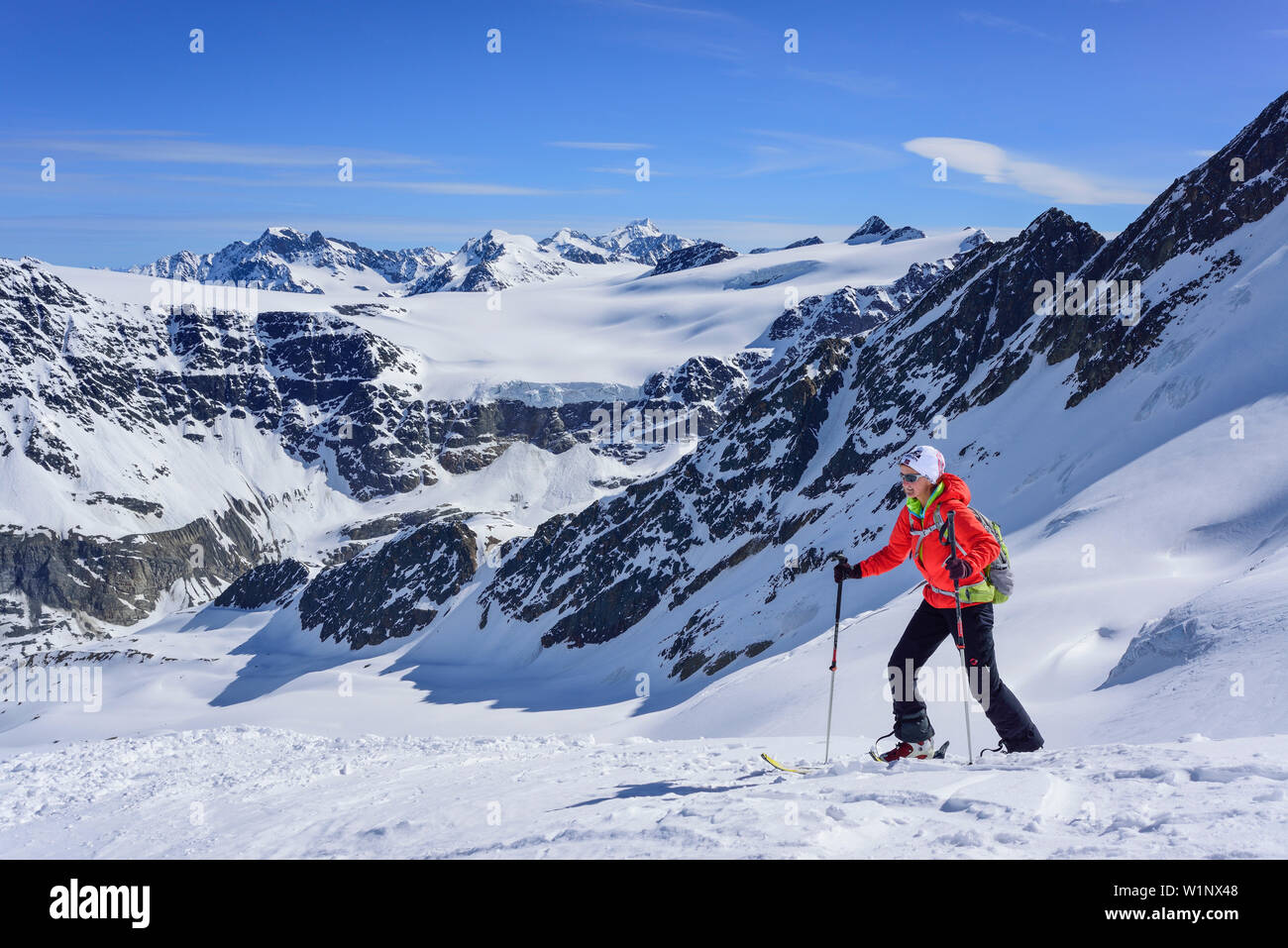 Woman back-country skiing ascending towards Aeusserer Baerenbartkogel, Aeusserer Baerenbartkogel, valley of Langtaufers, Vinschgau, Oetztal Alps, Sout Stock Photo