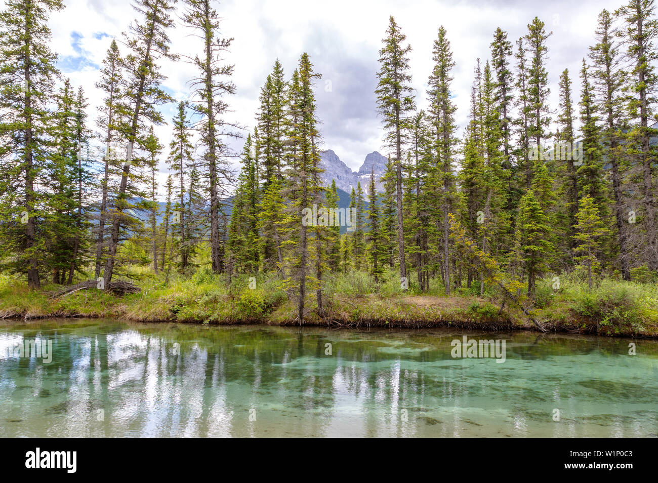Policeman Creek in Canmore with the famous Three Sisters mountain peaks in the background. Stock Photo