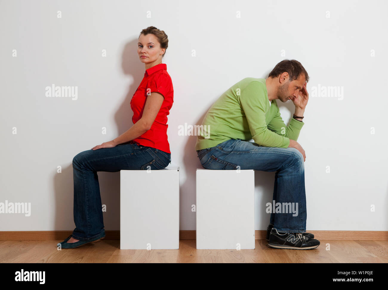 Angry couple sitting back to back Stock Photo