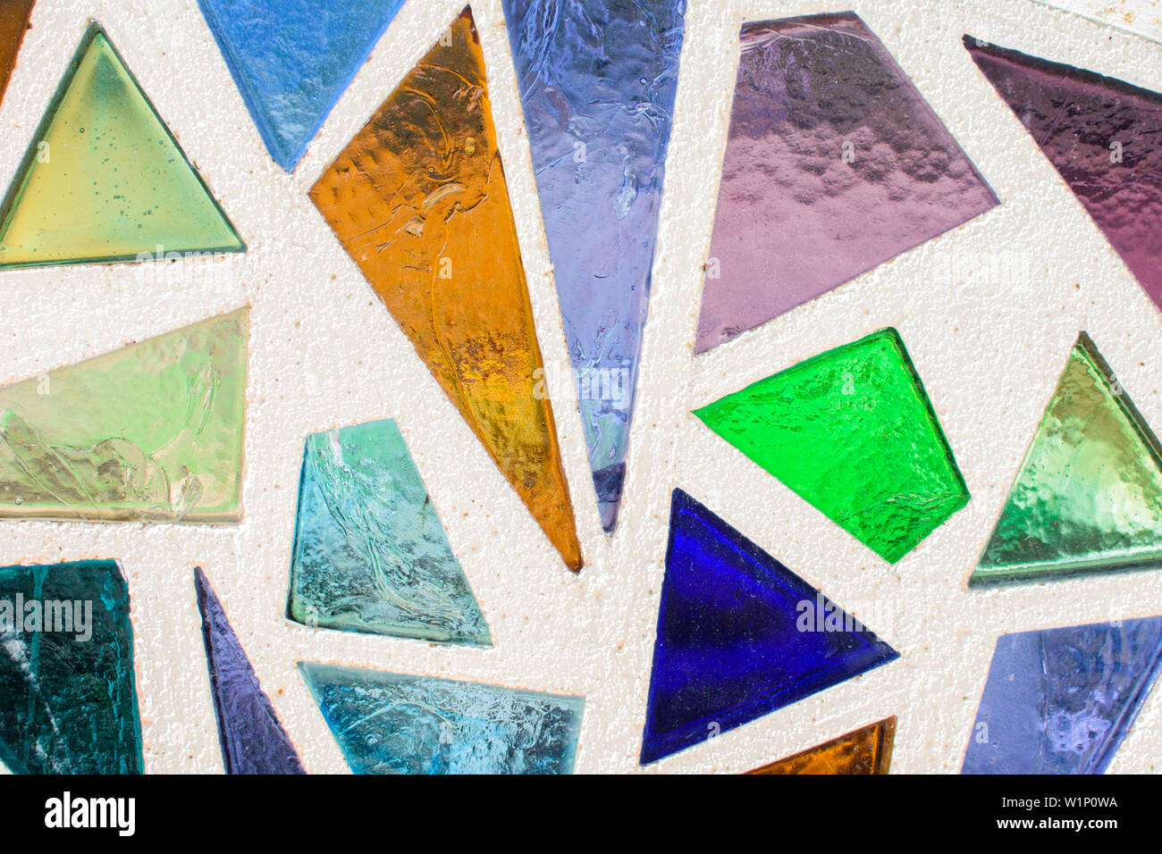 Mosaic surface made of multi-colored glass. Abstract mosaic glass tiles patterned background. CLose up. Stock Photo