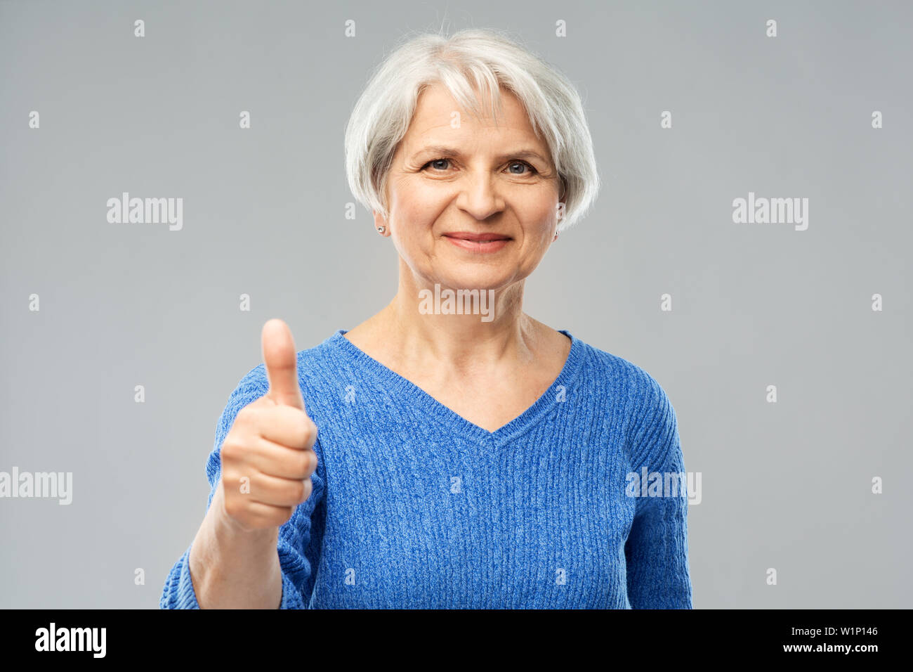 smiling senior woman r showing thumbs up Stock Photo - Alamy