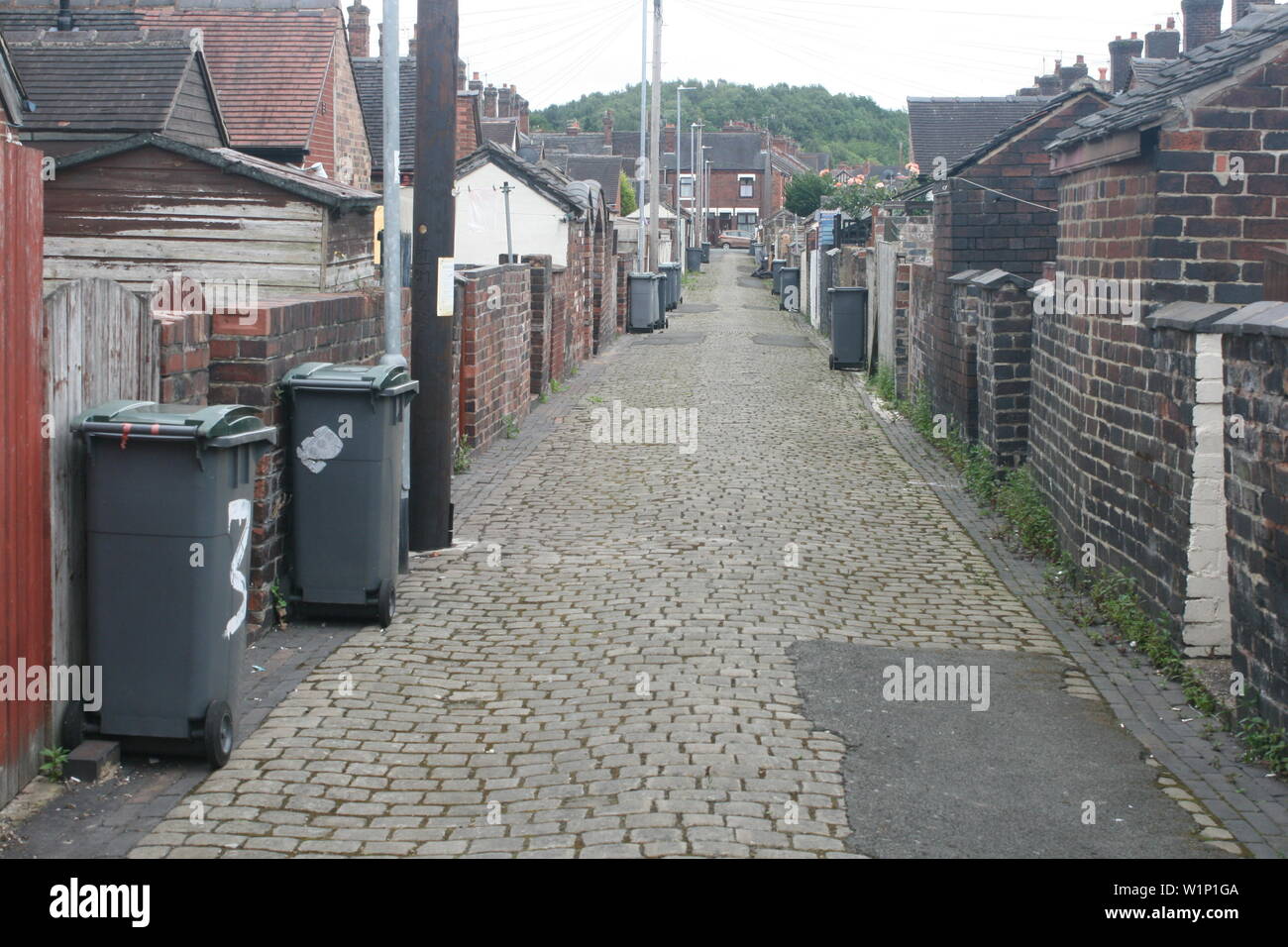 Back alley of terraced houses showing rubbish bins in Fenton, Stoke-on-Trent Stock Photo