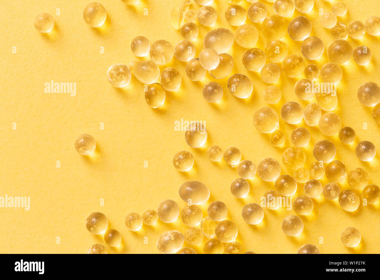Silica gel granules over yellow background. Silicon moisture Stock