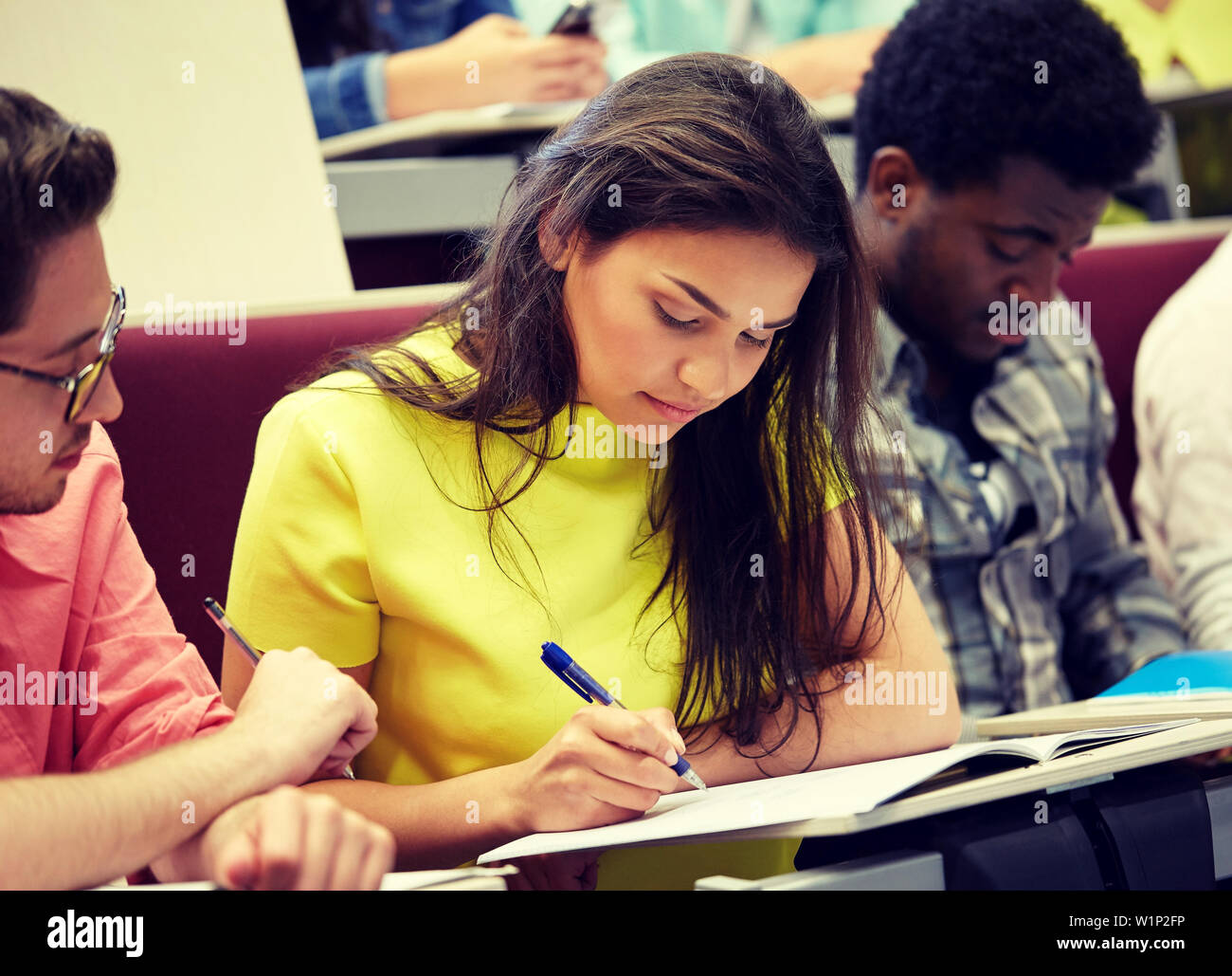 group of international students writing at lecture Stock Photo - Alamy