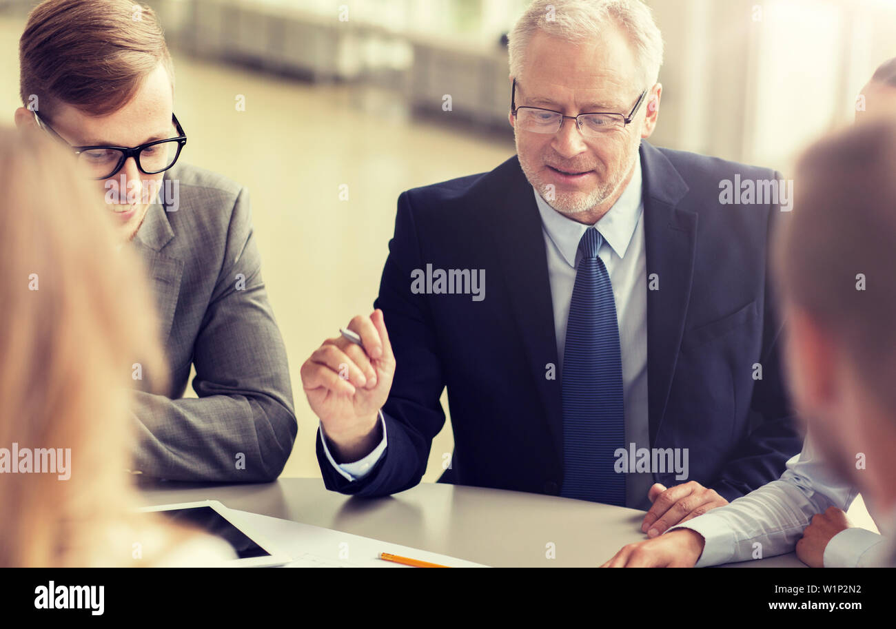 architects with tablet pc and blueprint at office Stock Photo