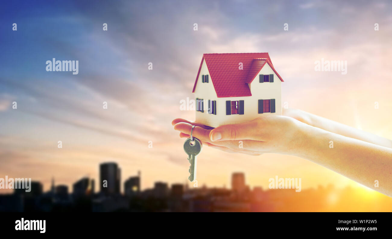 close up of hands holding house model and keys Stock Photo - Alamy