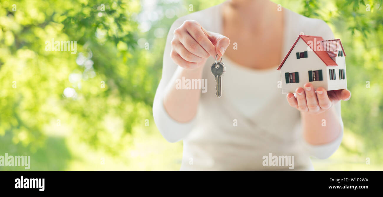 close up of hands holding house model and keys Stock Photo - Alamy
