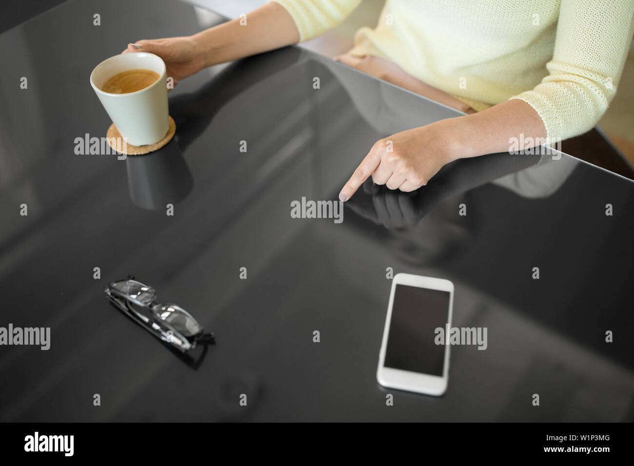 woman with coffee using black interactive panel Stock Photo