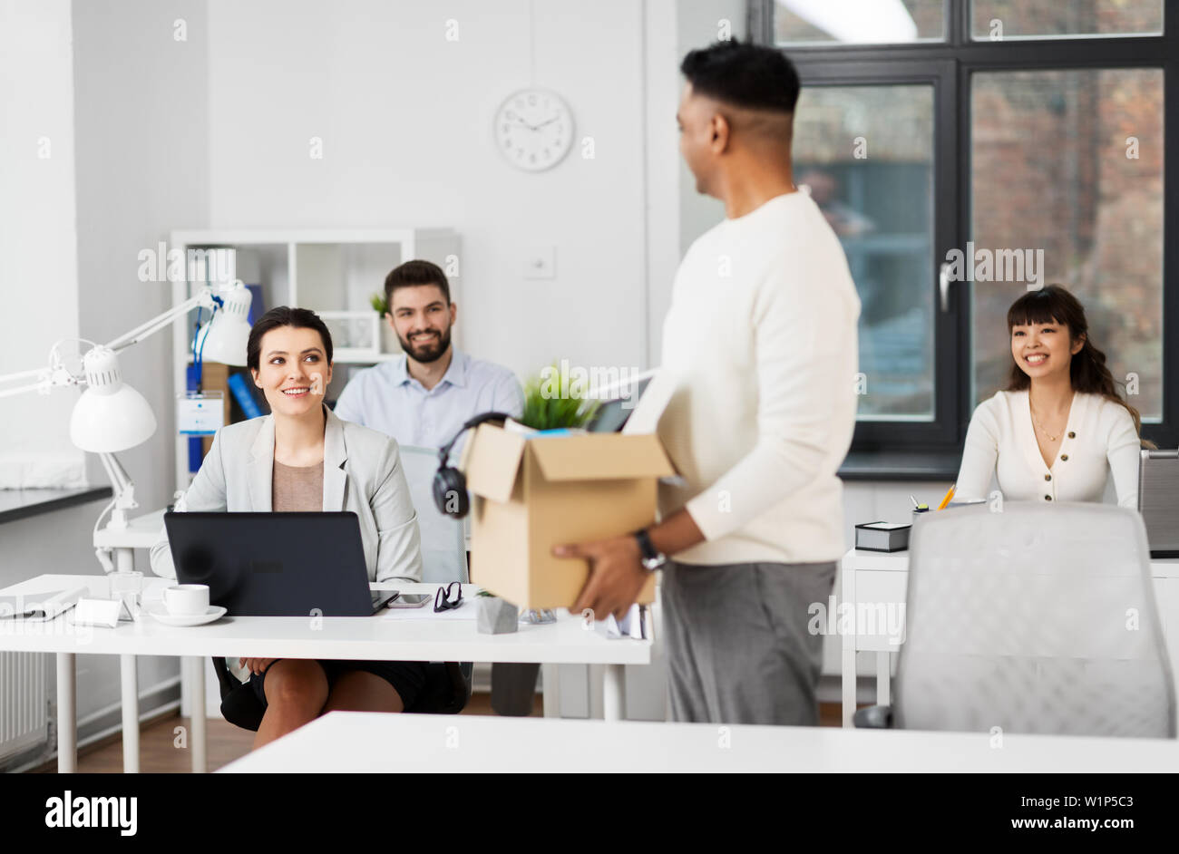 office workers looking at colleague quitting job Stock Photo Alamy