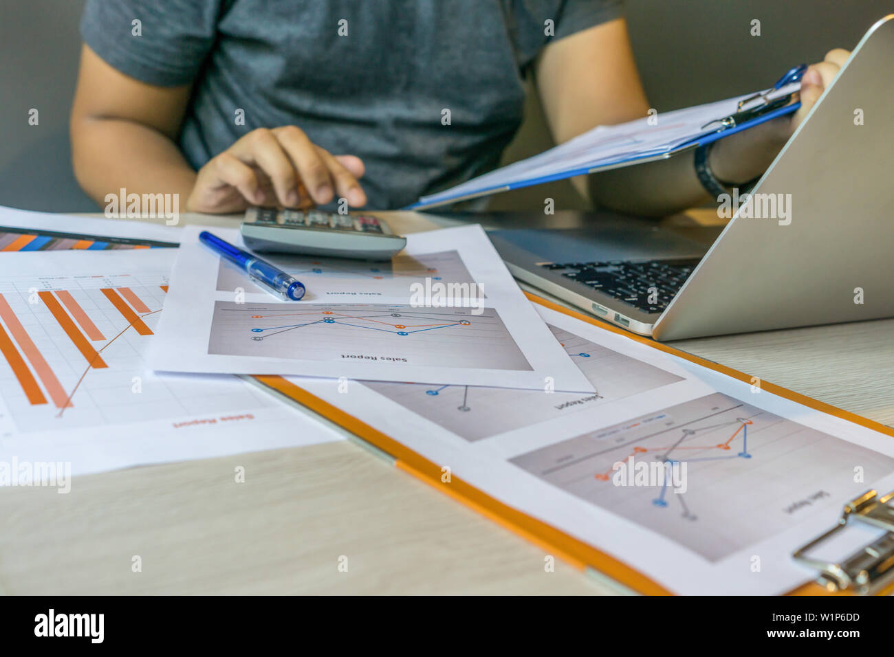 Close up of human hands using calculator , holding document Stock Photo