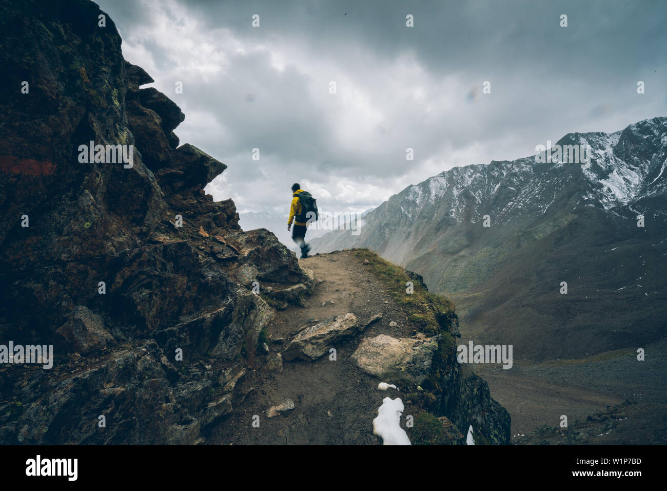 Climber climbing in bad weather, E5, Alpenüberquerung, 6th stage, Vent,Niederjochbach, Similaun hut, Schnalstal, Vernagt reservoir, Meran Stock Photo