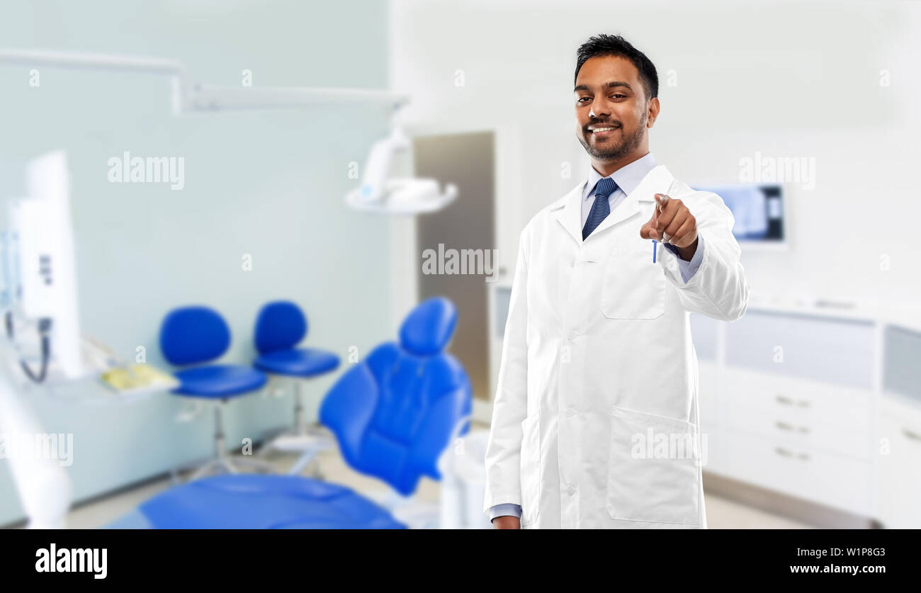 indian dentist pointing to you at dental clinic Stock Photo