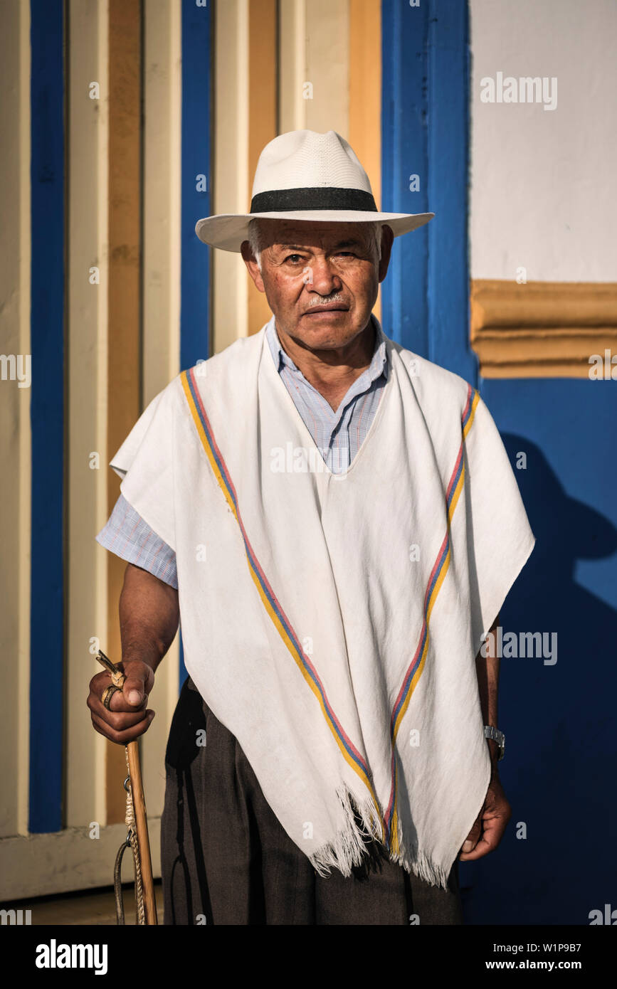 portrait of old man with stick and hat in front of colonial house, Salento, UNESCO World Heritage Coffee Triangle, Departmento Quindio, Colombia, Sout Stock Photo