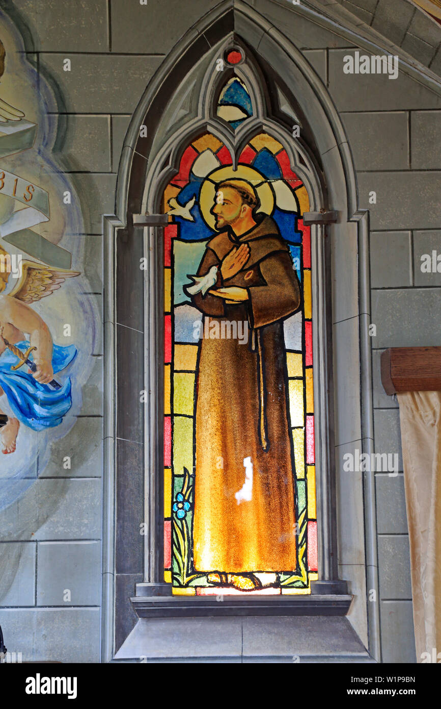 View of the painted glass window depicting St Francis of Assisi in the Italian Church Lambholm Island Orkney Scotland Stock Photo