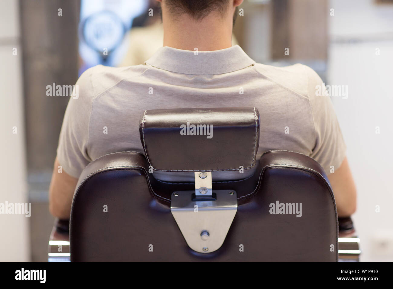 man sitting in chair at or hair salon Stock Photo Alamy