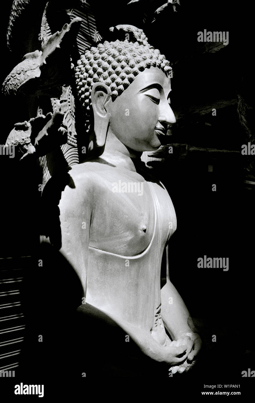 Buddha statues in Bamrung Muang Road in Bangkok in Thailand in Southeast Asia Far East. B&W Stock Photo