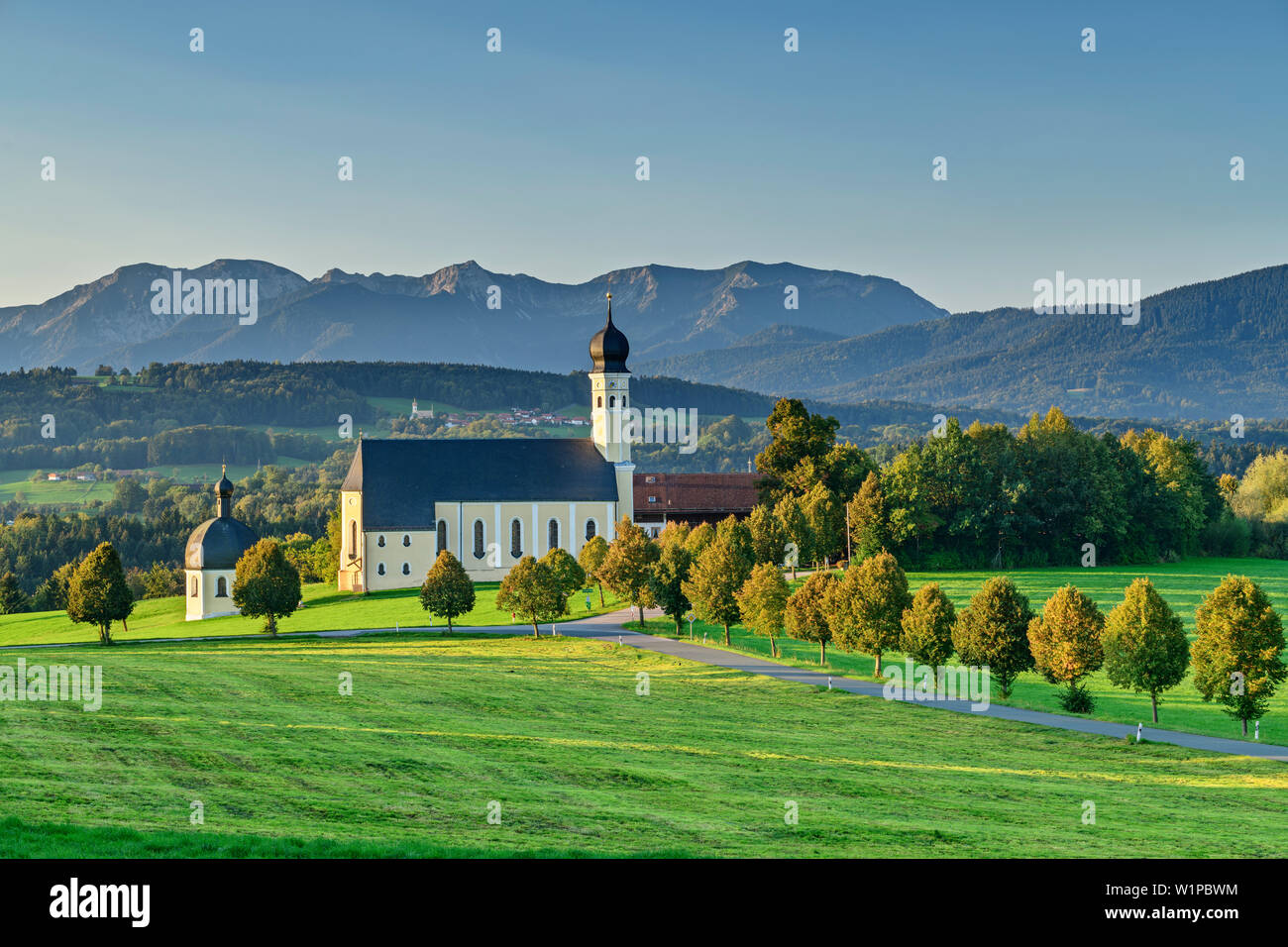 Church of wilparting with mangfall mountains in the background, Wilparting, Sunderland, Upper Bavaria, Bavaria, Germany Stock Photo