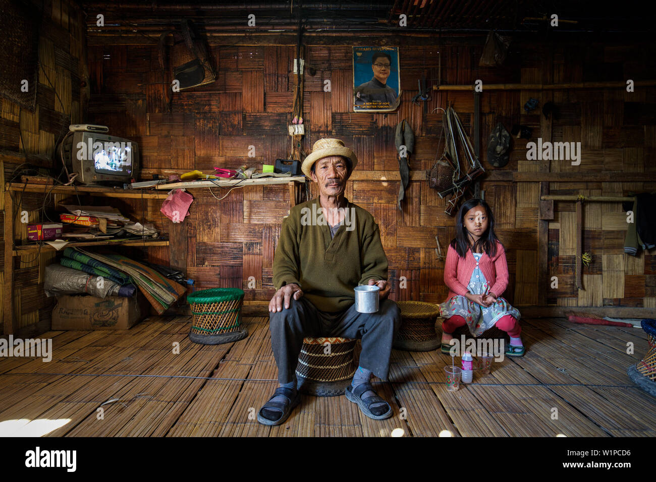 Family in traditional wooden hut, Arunachal, India, Asia Stock Photo