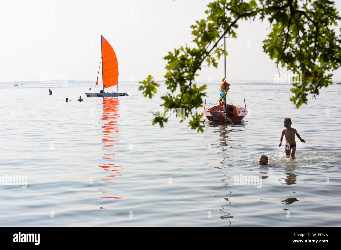 Swimming in the lake Müritz, beach, boats, sailing boats, windsurfing
