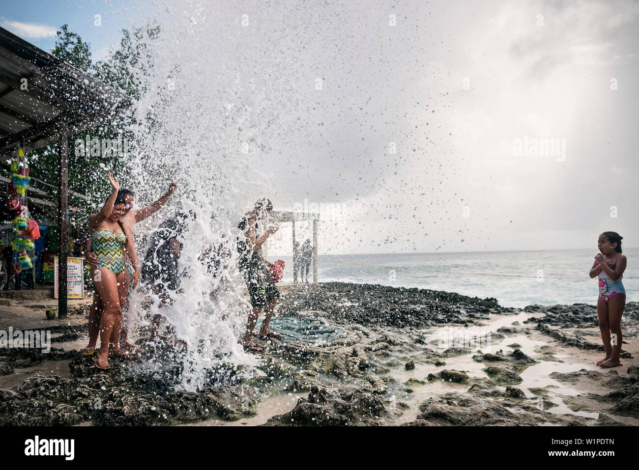 Colombians having fun at „Blowhole“ at coast of San Andres Island, Departamento San Andrés and Providencia, Colombia, Caribbean Sea, Southamerica Stock Photo