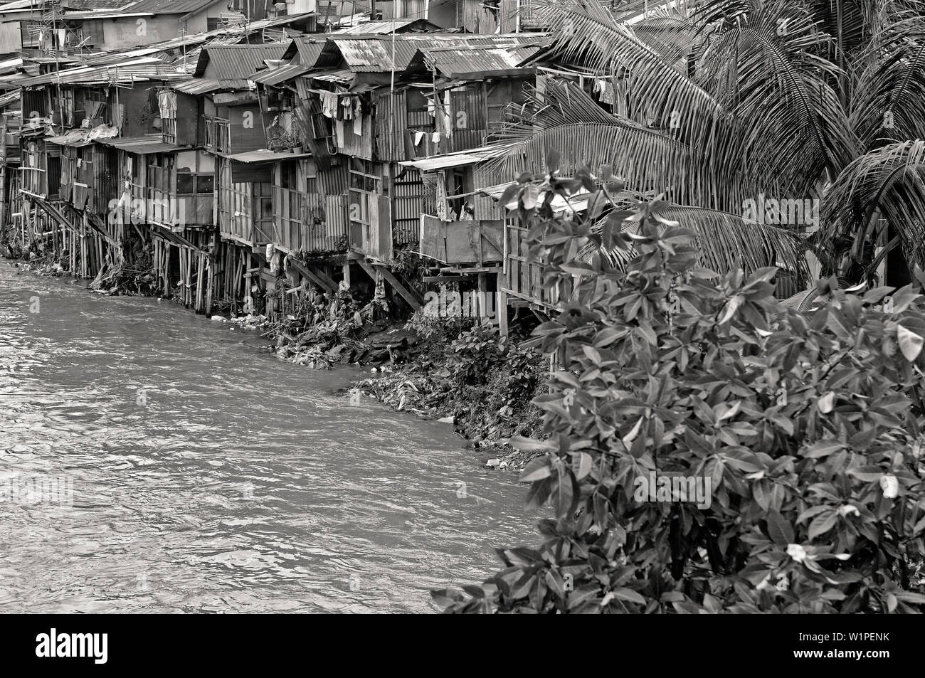 jakarta, indonesia - n2009.11.16: kampung melayu squatter living quarter at the banks of ciliwung river Stock Photo