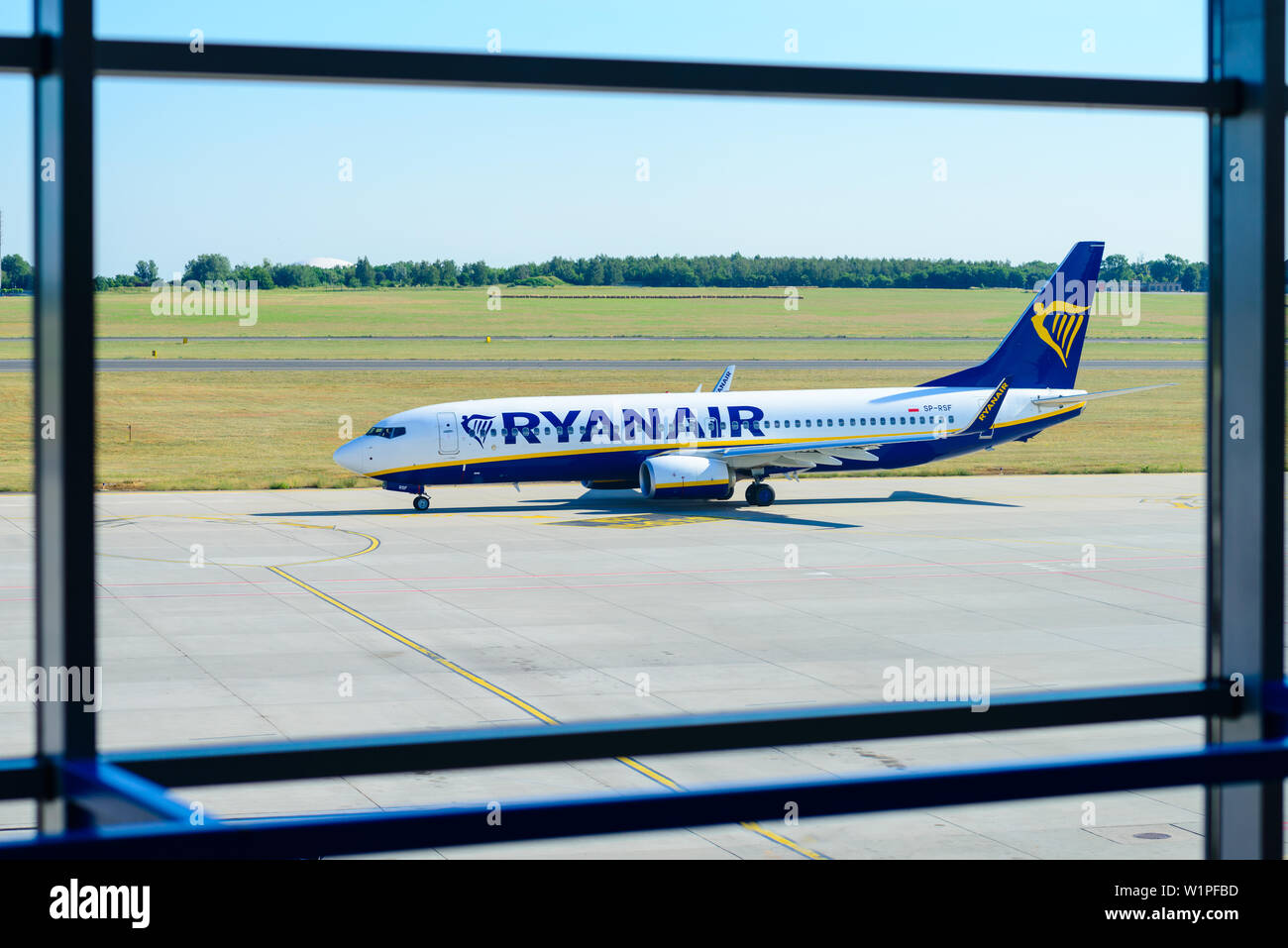 Poznan, Poland - June 18, 2019: Ryanair plane seen through the window of Lawica Airport in Poznan Stock Photo