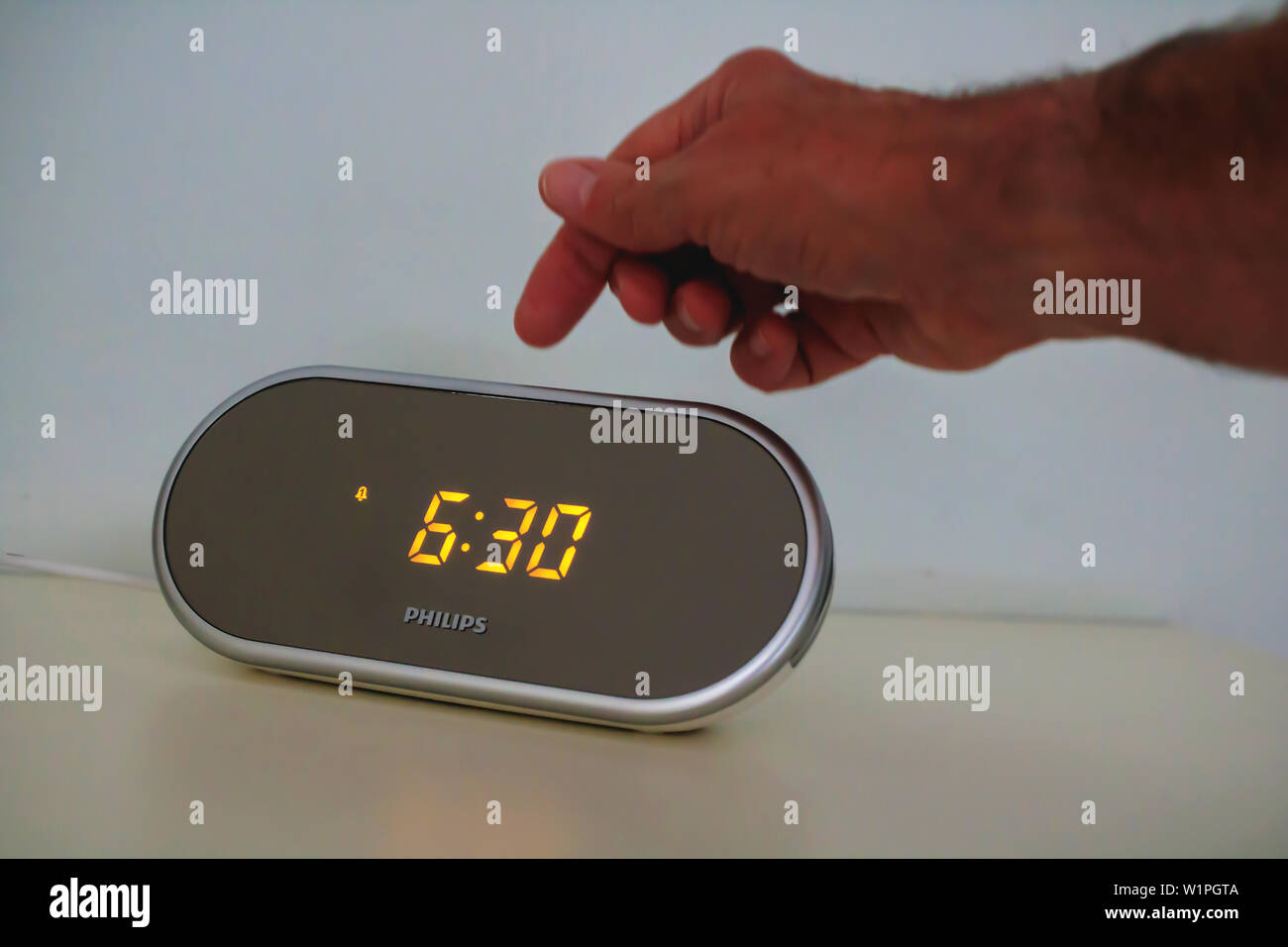 A hand switching off an early morning call on digital alarm clock radio Stock Photo - Alamy