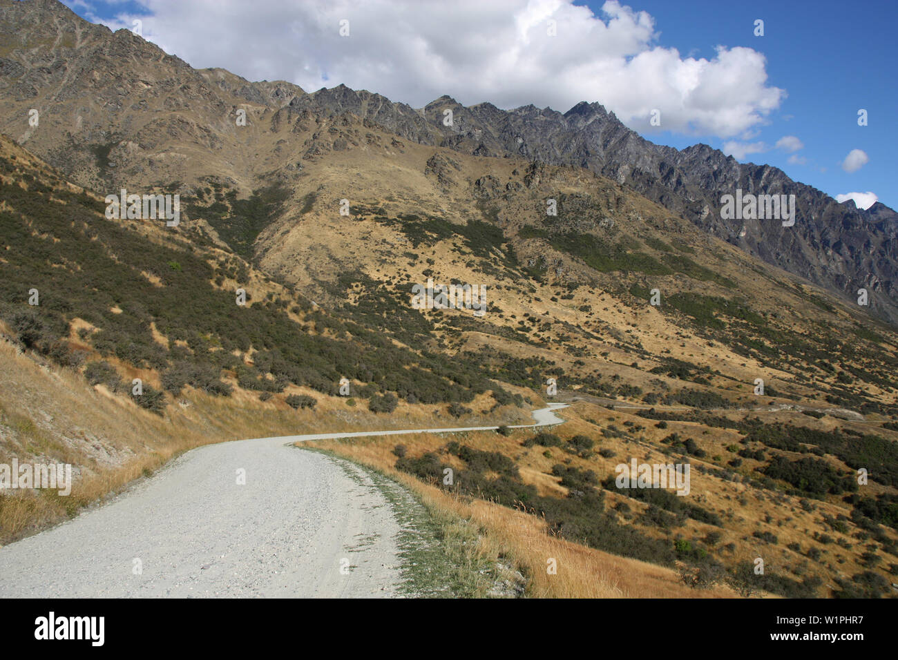 The Remarkables gravel road. Mountains in New Zealand's Otago region. South Island. Stock Photo