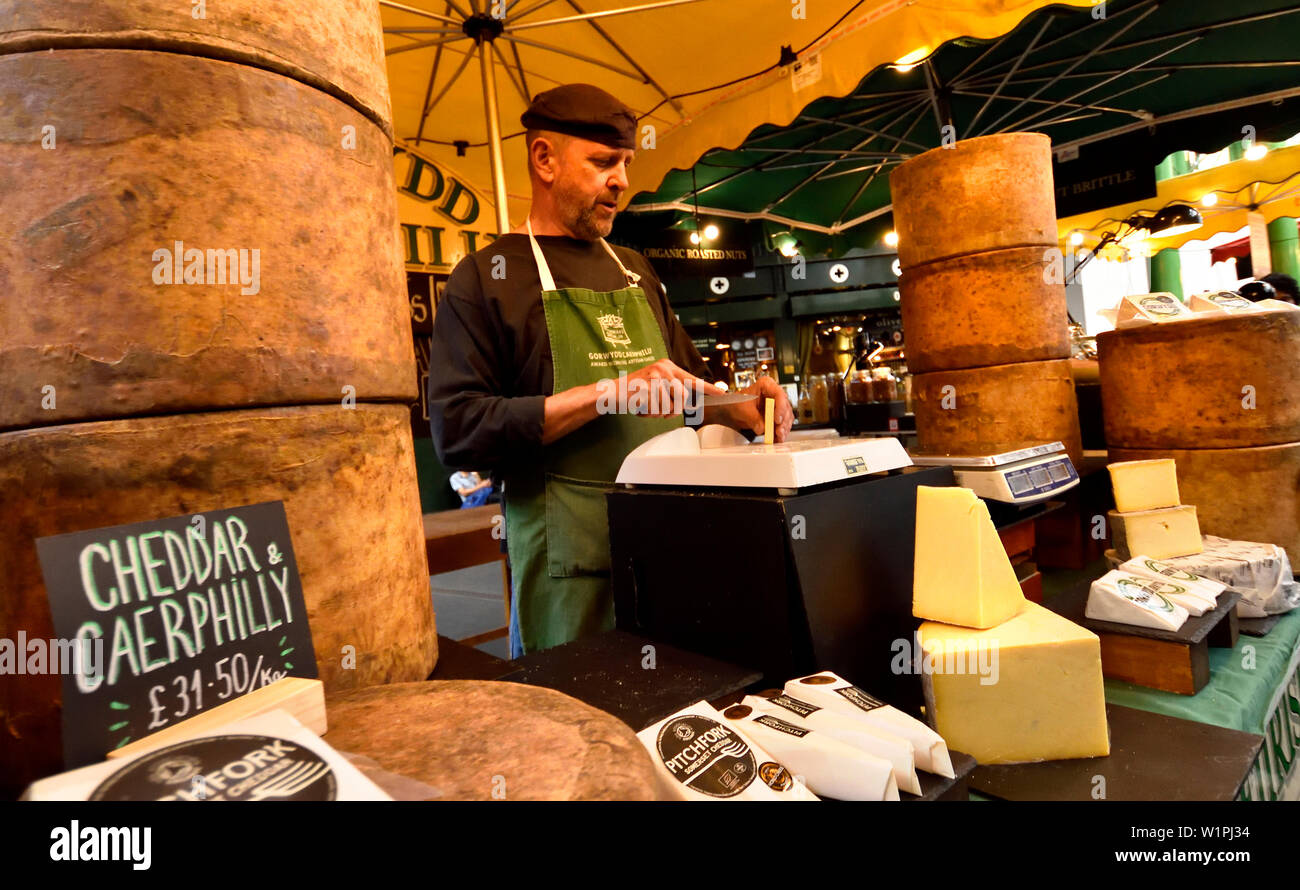 London, England, UK. Borough Market, Southwark. Man on a cheese stall Stock Photo