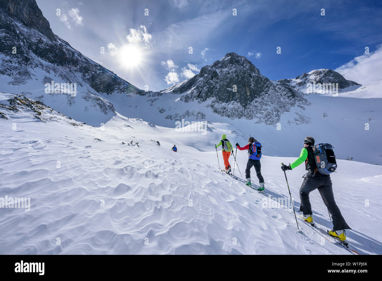 Four persons backcountry skiing ascending towards Fritzerkogel, Fritzerkogel, Tennengebirge range, Salzburg, Austria Stock Photo