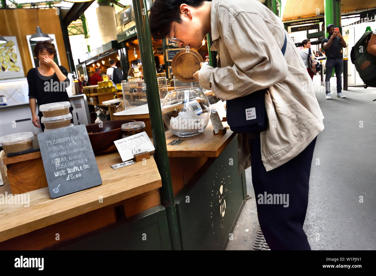 London, England, UK. Borough Market, Southwark. Asian man at a truffle stall Stock Photo
