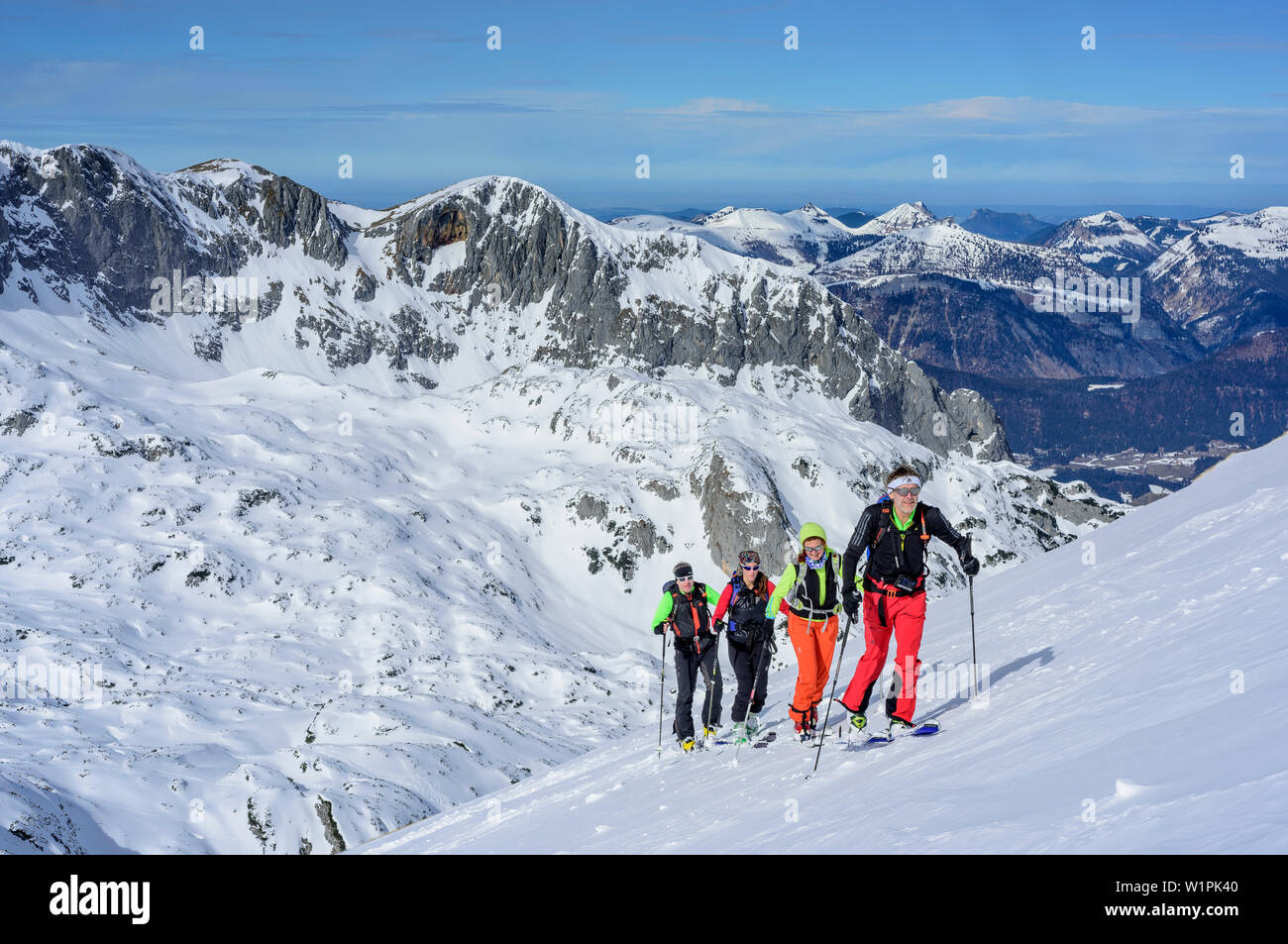 Four persons backcountry skiing ascending towards Fritzerkogel, Fritzerkogel, Tennengebirge range, Salzburg, Austria Stock Photo