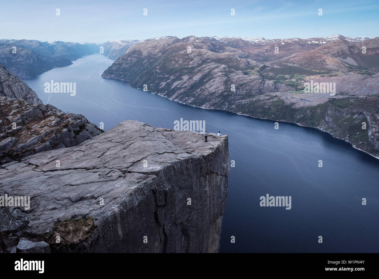 one person sitting with tailor seat at Preikestolen or Prekestolen, Lysefjord, Rogaland Province, Norway, Scandinavia, Europe Stock Photo