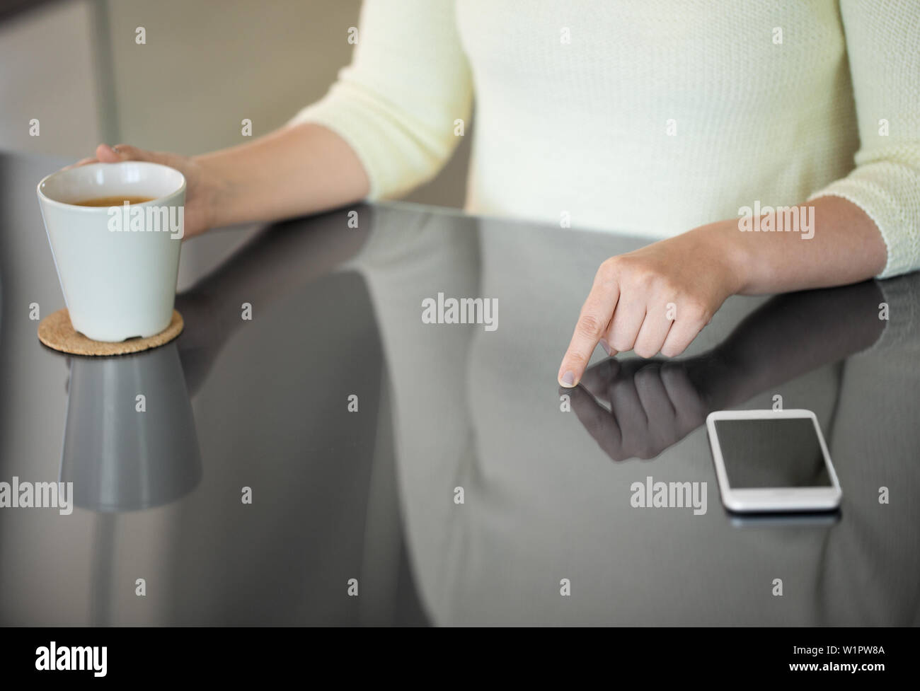 woman with coffee using black interactive panel Stock Photo