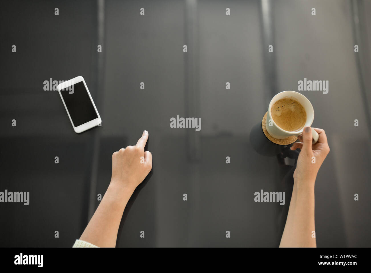 woman with coffee using black interactive panel Stock Photo