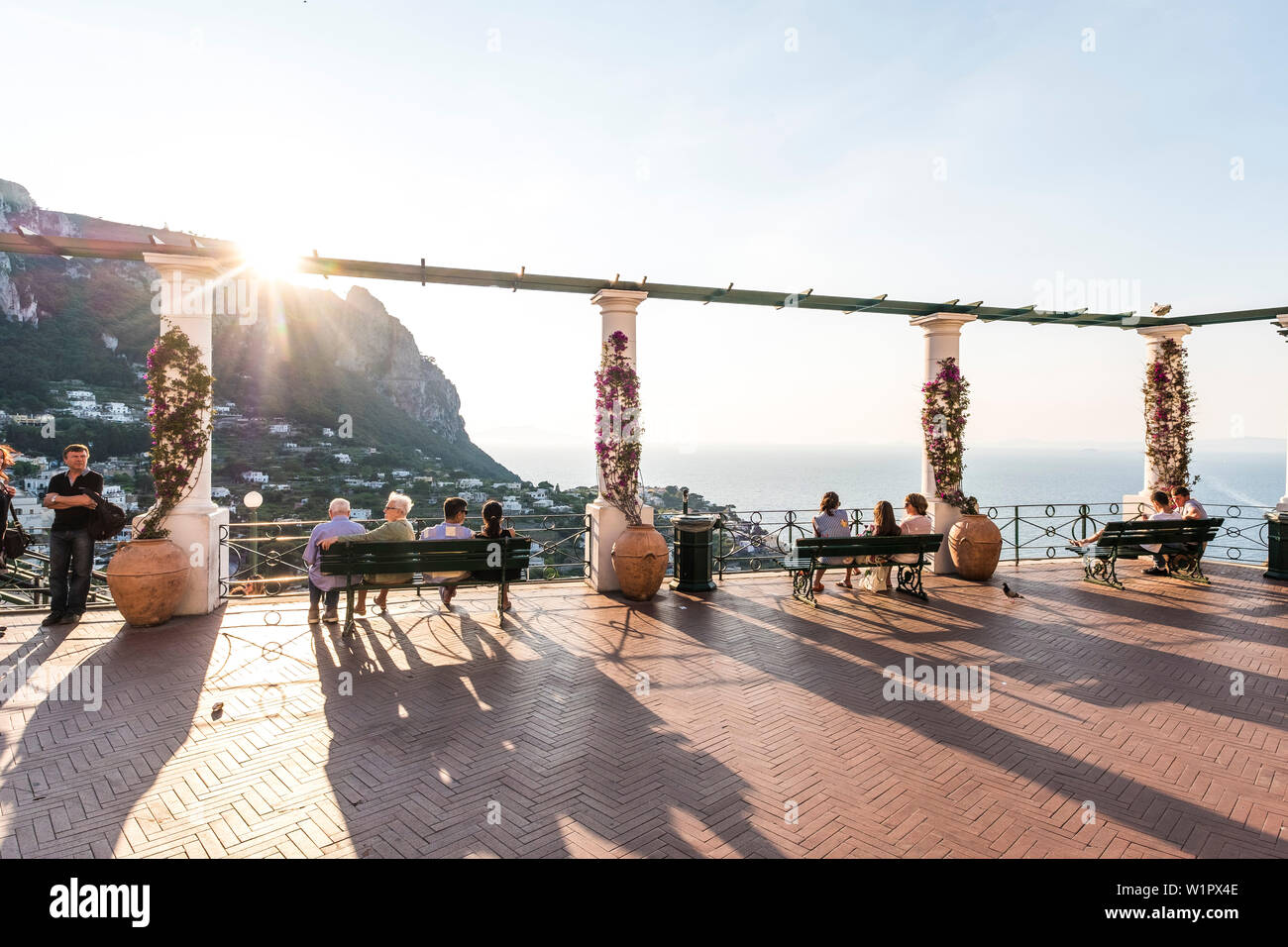 People gazing towards the sunset on the piacetta of Capri, island of Capri, Gulf of Naples, Italy Stock Photo