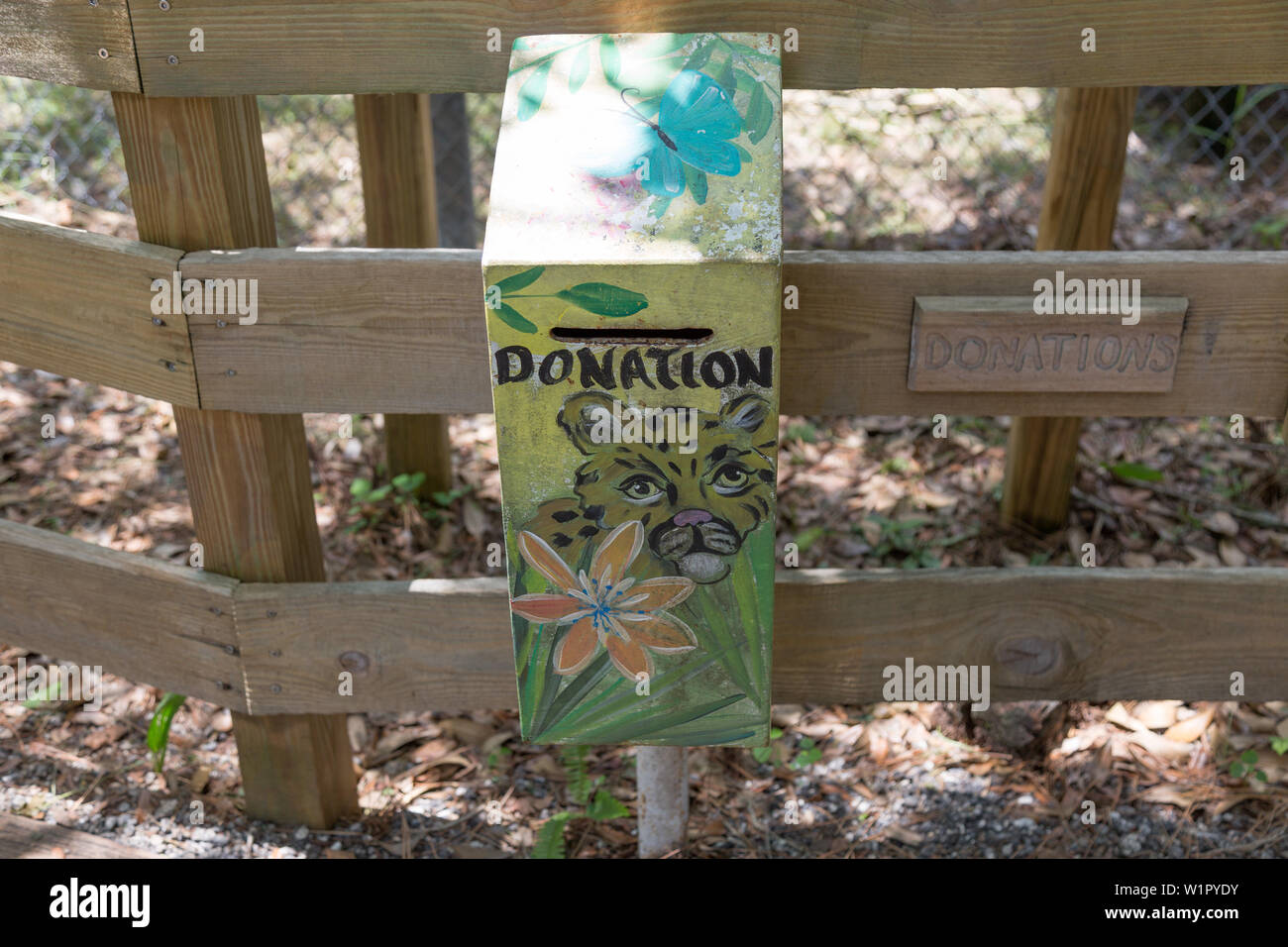 A decorated donation box is next to a fence outside the Busch Wildlife Sanctuary in Jupiter, Florida, USA. Stock Photo