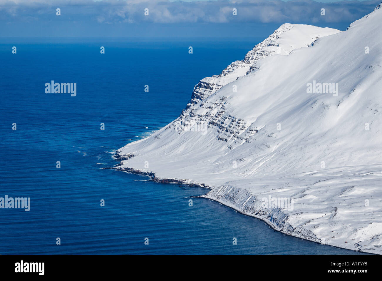 Snowy slopes end at sea level, Tröllaskagi, Iceland, Scandinavia Stock Photo