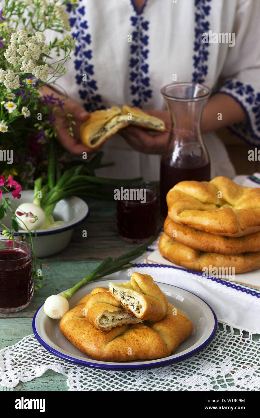 Traditional homemade Romanian and Moldovan pies - Placinta, served with wine. Rustic style, selective focus. Stock Photo