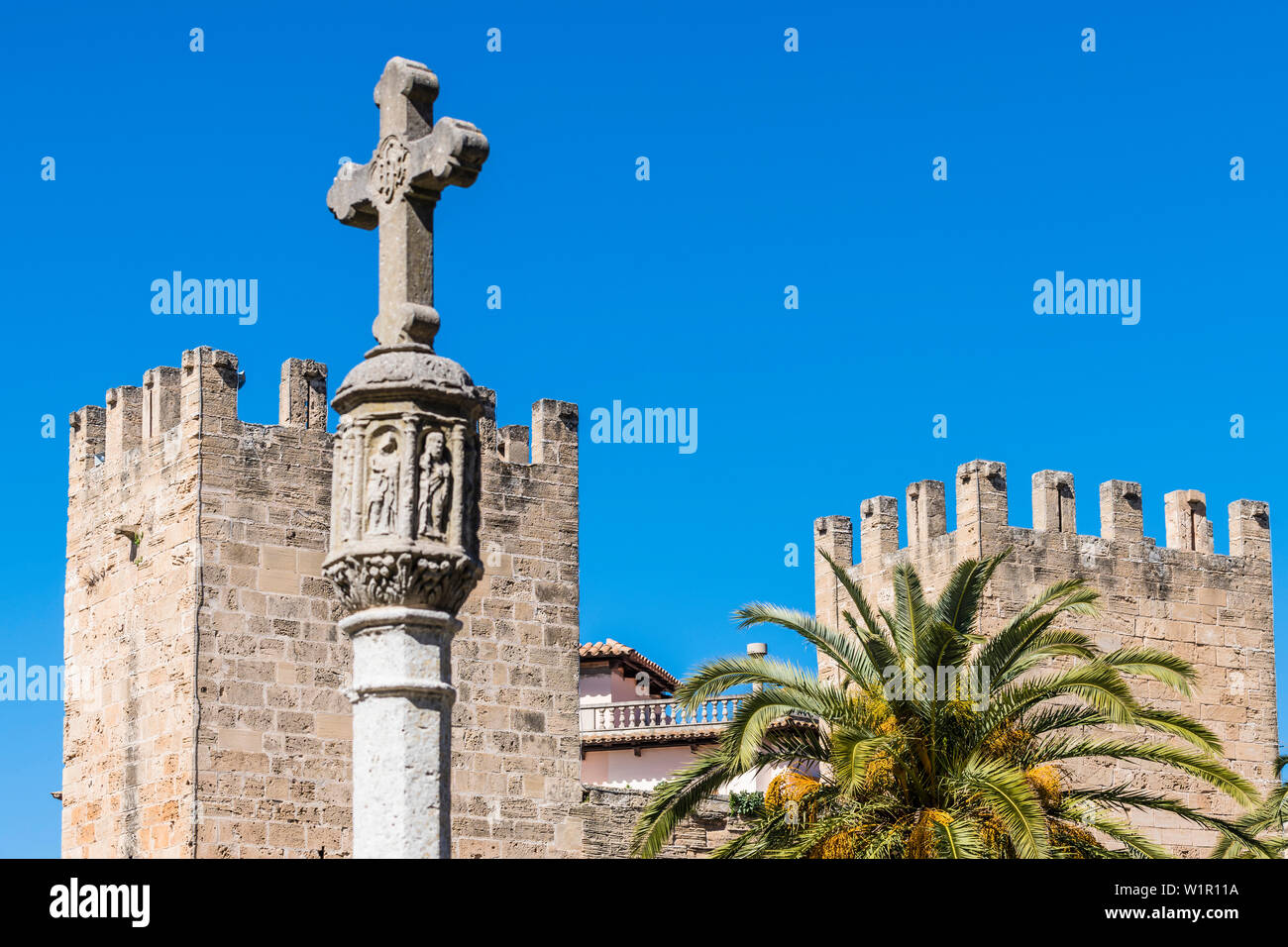 City gate with column and stone cross, Mallorca, Spain Stock Photo