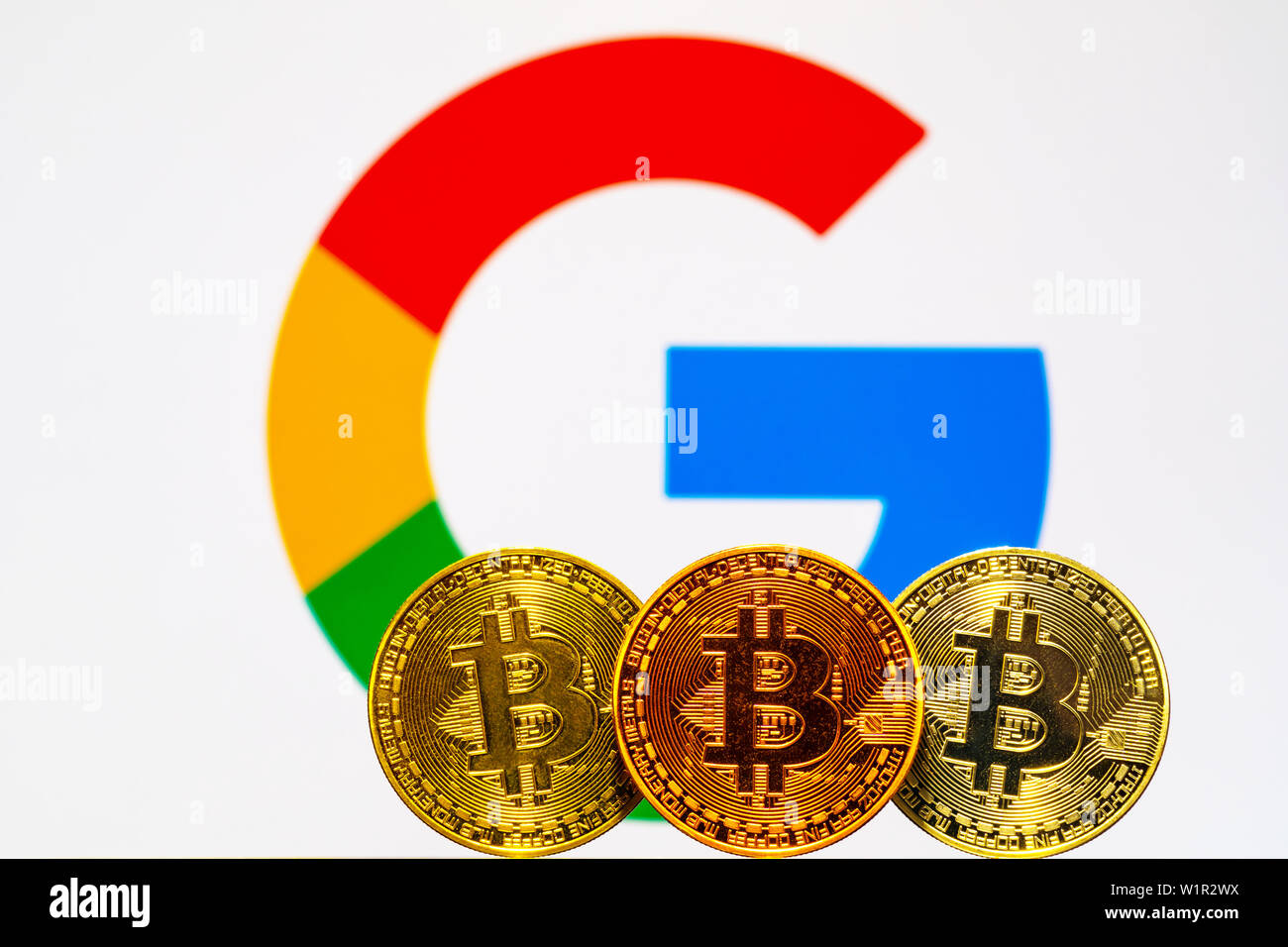 Gold Bitcoin coins with the Google logo on background screen Stock Photo -  Alamy