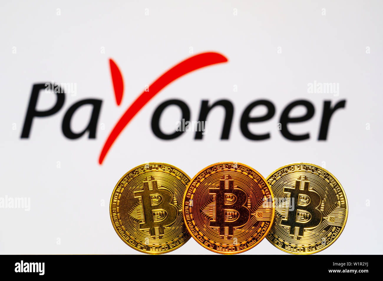 Gold Bitcoin coins with the Payoneer logo on background screen. A new type  of business finance concept Stock Photo - Alamy
