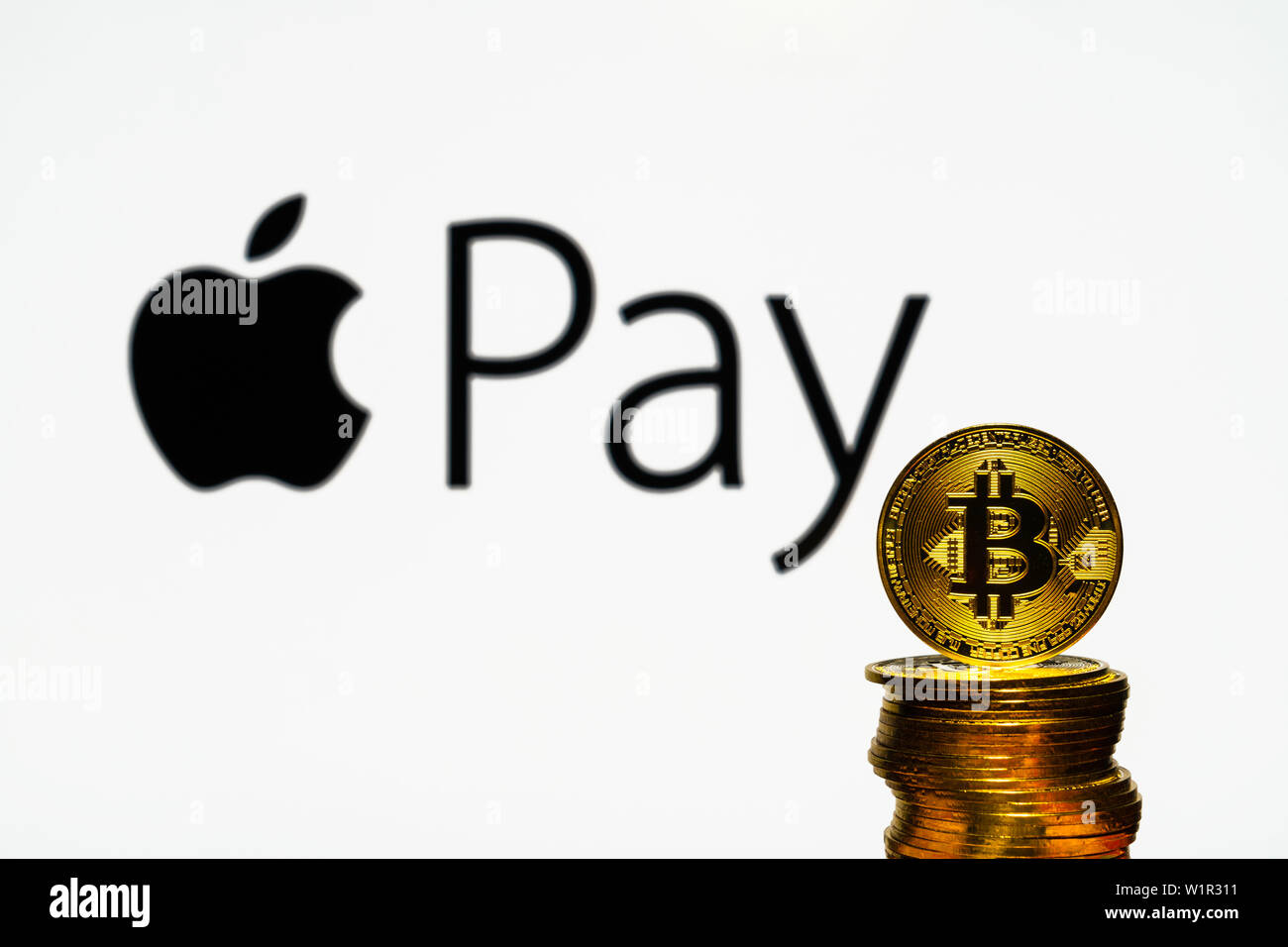 Gold Bitcoin coins with the Apple logo on background screen. A new type of  business finance concept Stock Photo - Alamy