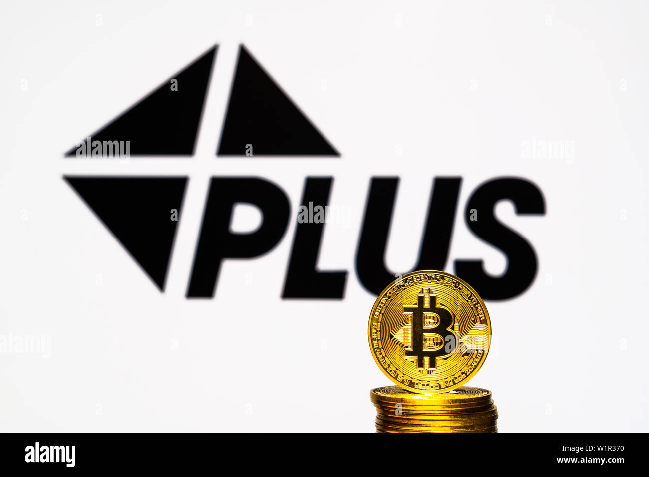 Gold Bitcoin coins with the Visa Plus System logo on background screen. A  new type of business finance concept Stock Photo - Alamy