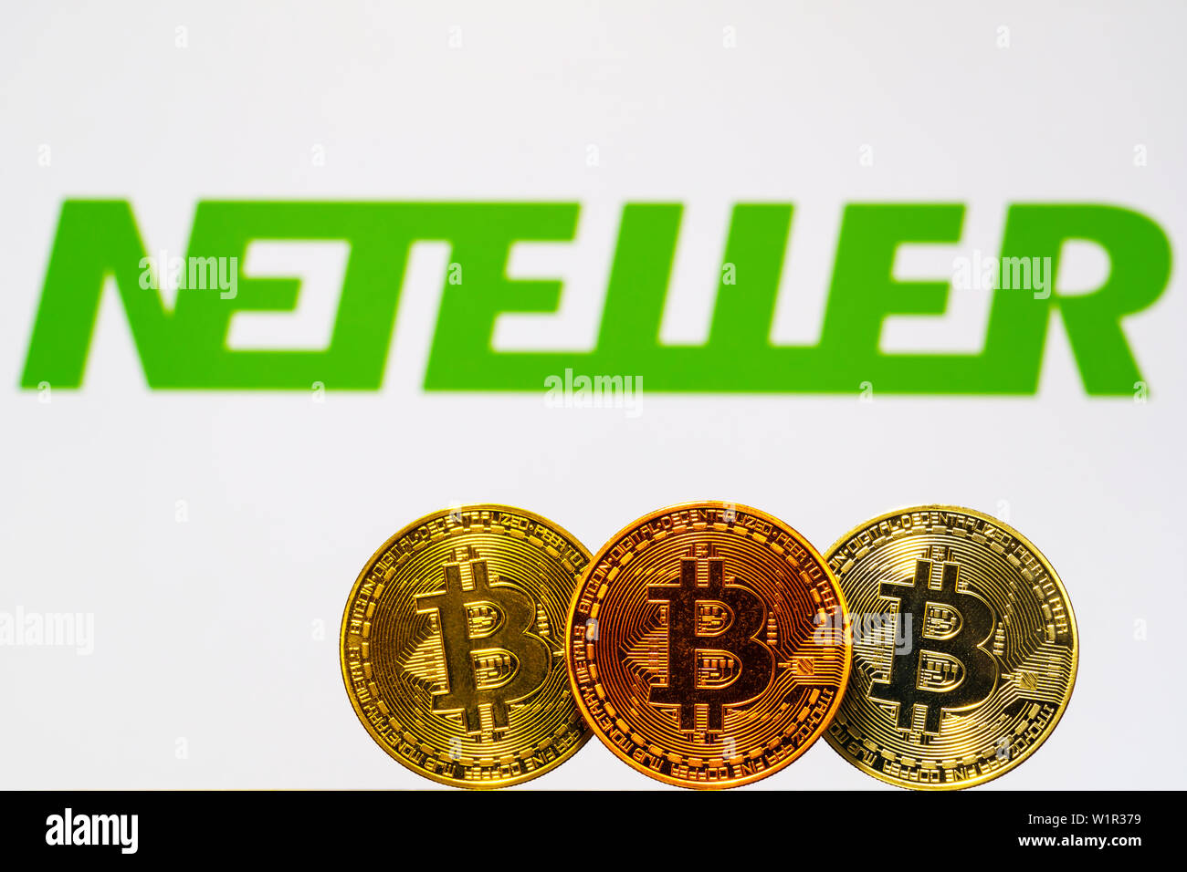 Gold Bitcoin coins with the Neteller logo on background screen. A new type  of business finance concept Stock Photo - Alamy