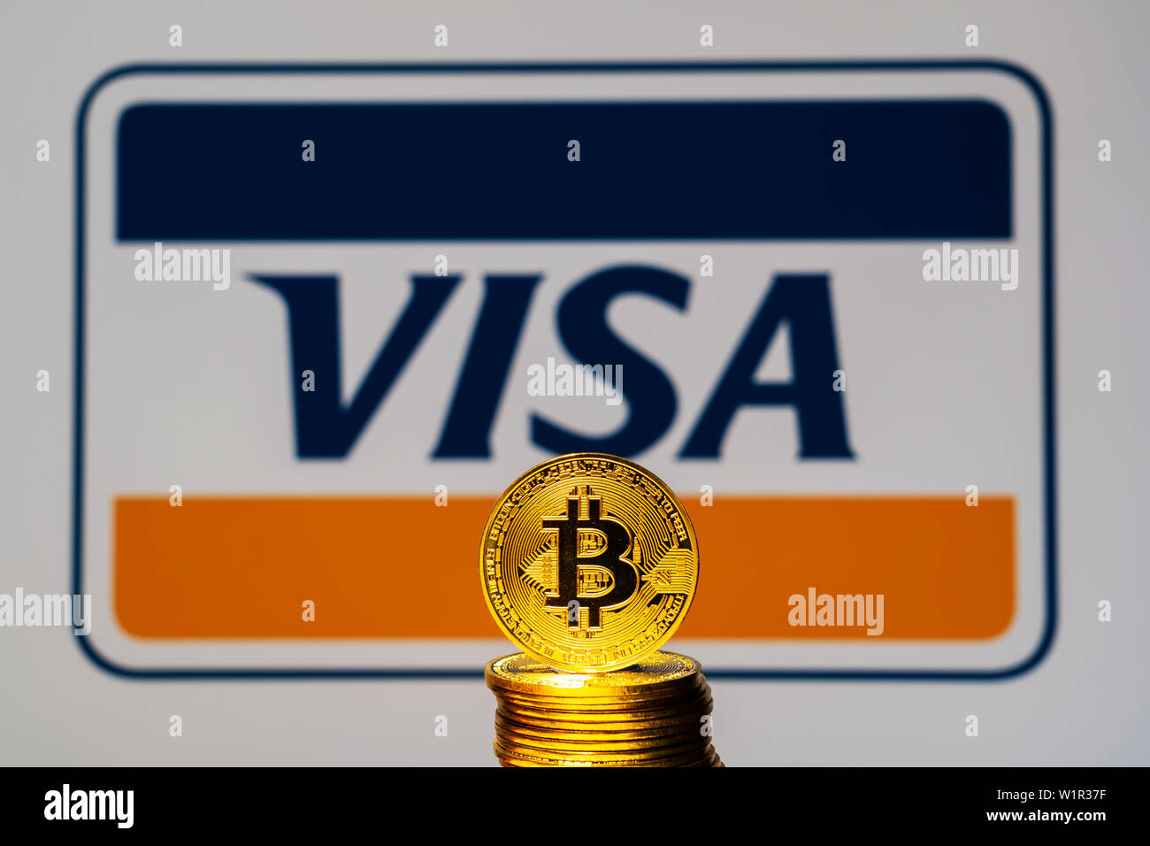 Gold Bitcoin coins with the Visa Plus System logo on background screen. A  new type of business finance concept Stock Photo - Alamy